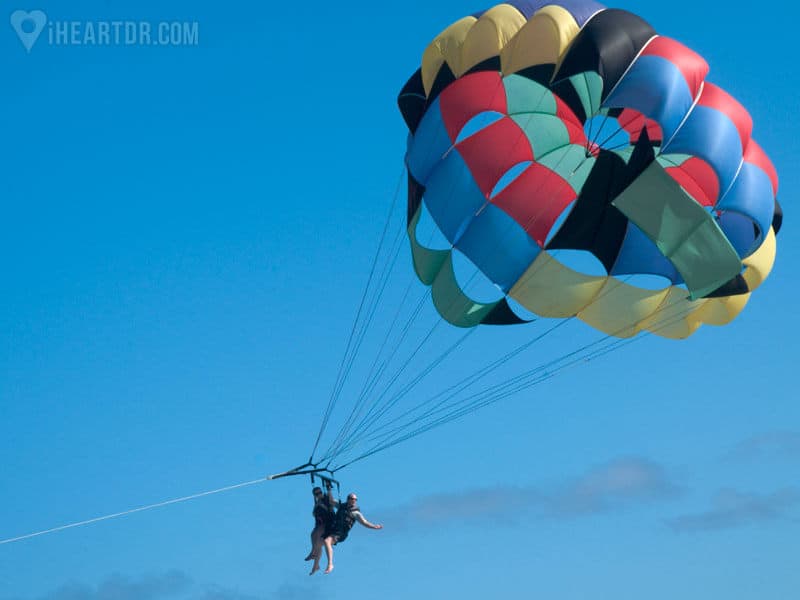 Man parasailing in Punta Cana waiving