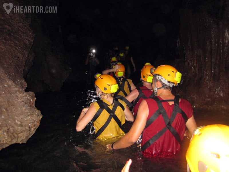 Group waist deep in an underground river