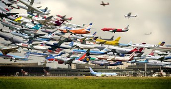 Many planes taking off from an airport