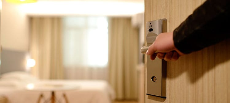 Hand opening a hotel door